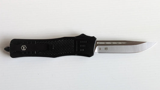 Large, lightweight Griffin knife. The blade comes standard in a D2 steel with a Drop Point blade with a non-serrated edge. The handle is a black ultralight anodized aluminum with a black switch. There is a belt clip for ease of carrying as well as glass break for safety.